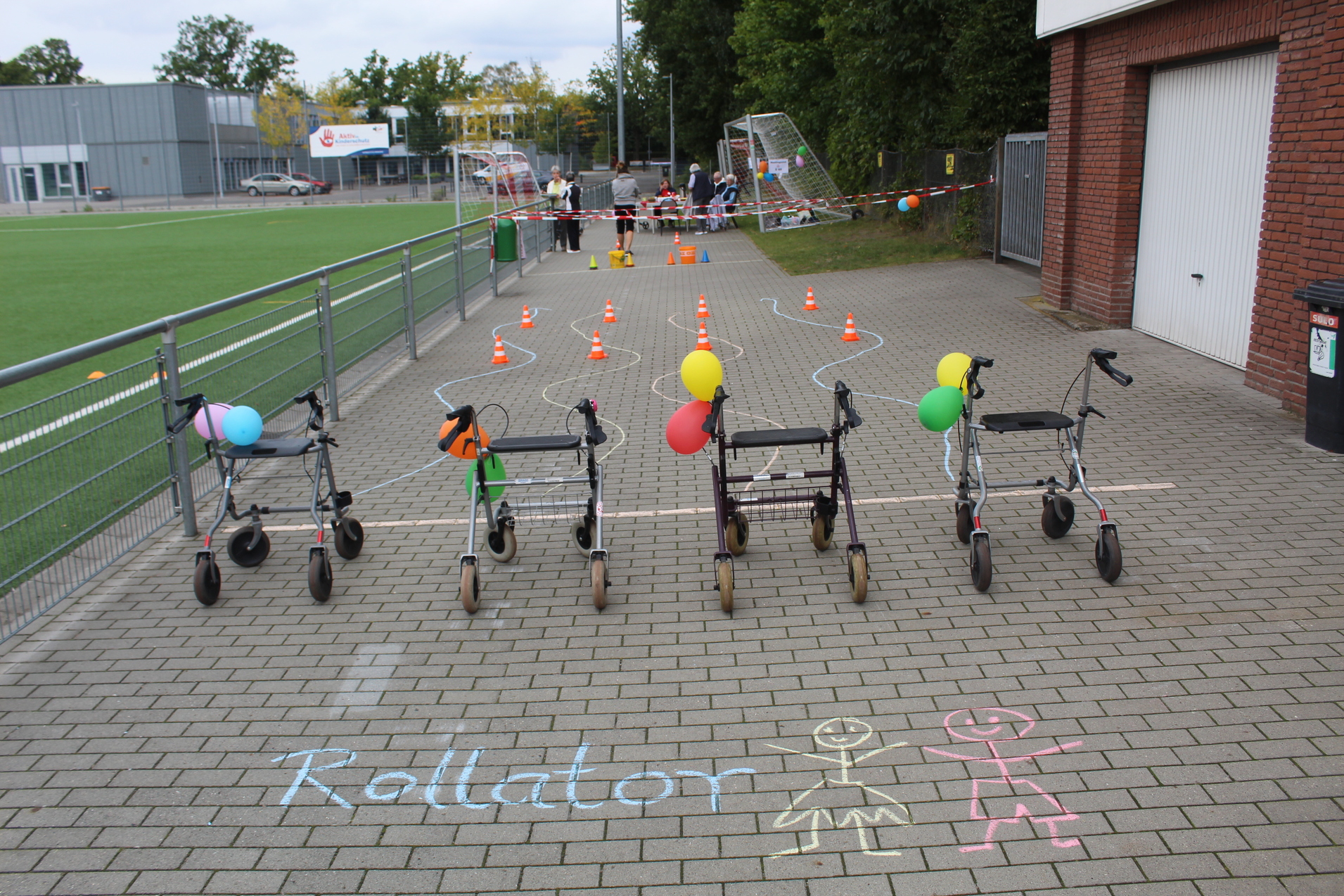 Vier Rollatoren warten auf die Teilnehmer an der Startlinie des Rollatorparcours für Jung und Alt.