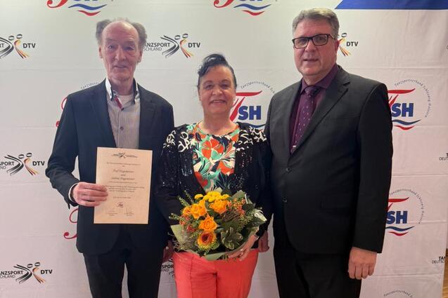 Ehepaar Hagemeister pr&auml;sentiert Urkunde und Blumenstrau&szlig; im Beisein von Jes Christophersen (TSH)